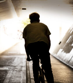 Urban bike rider from behind in tunnel.