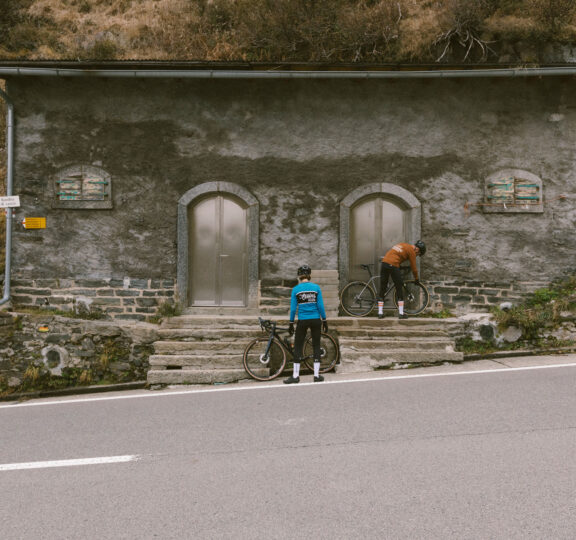 Two cyclists check their tires