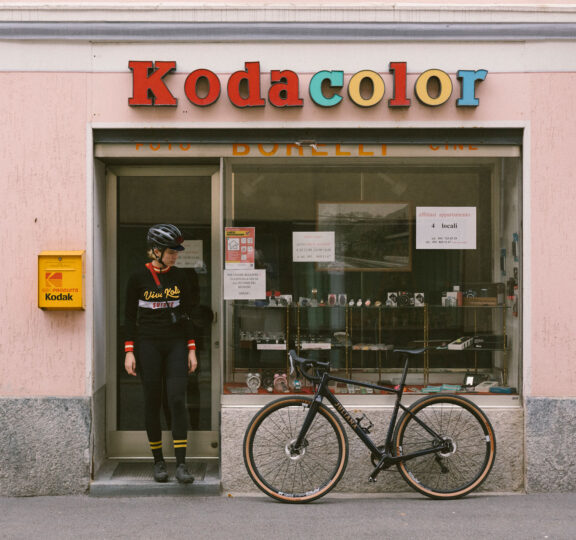 Cyclist in front of a photo store