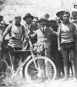 Group photo consisting of cyclists and spectators