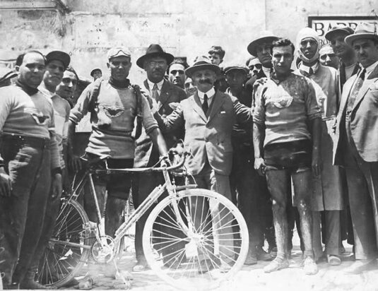 Group photo consisting of cyclists and spectators